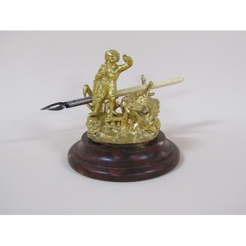 77 - A Victorian gilt bronze inkwell with the figure of a fisherman, the well with lift up cover and with... 