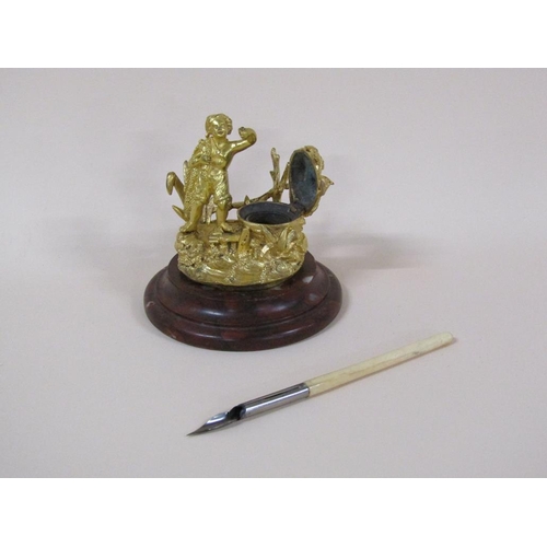 77 - A Victorian gilt bronze inkwell with the figure of a fisherman, the well with lift up cover and with... 