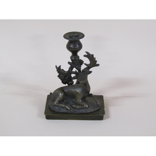 81 - A Regency bronze candlestick group with a recumbent deer, 8cm h, 11cm w.