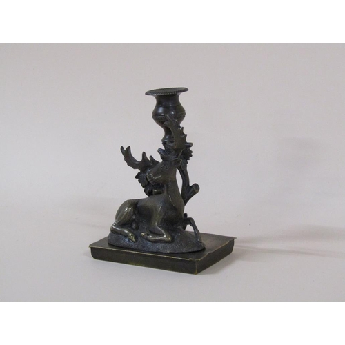 81 - A Regency bronze candlestick group with a recumbent deer, 8cm h, 11cm w.