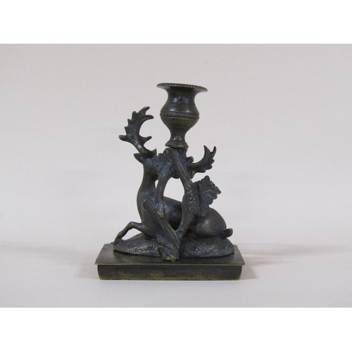 81 - A Regency bronze candlestick group with a recumbent deer, 8cm h, 11cm w.