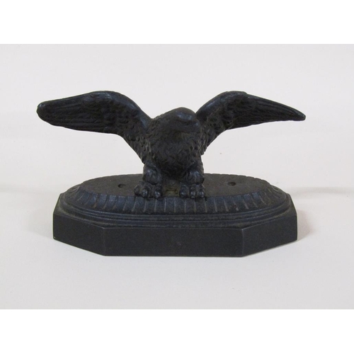 83 - A late Victorian cast iron figure of an eagle with outstretched wings on a shaped rectangular base, ... 