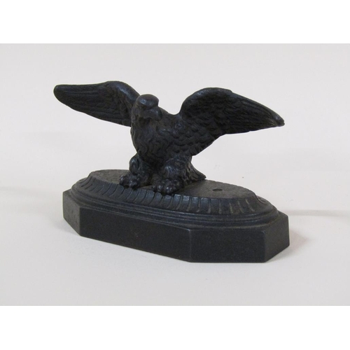 83 - A late Victorian cast iron figure of an eagle with outstretched wings on a shaped rectangular base, ... 