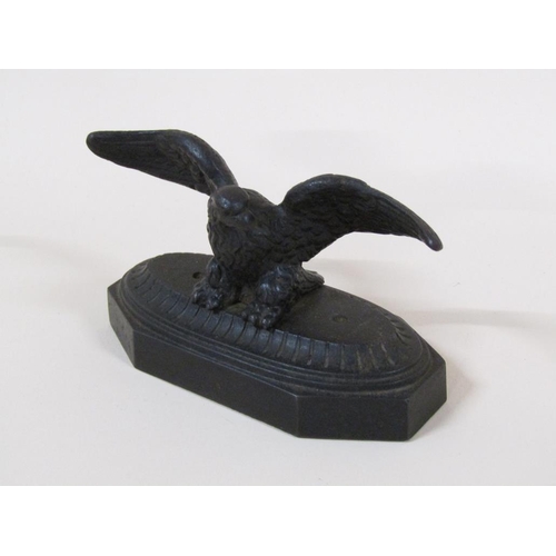 83 - A late Victorian cast iron figure of an eagle with outstretched wings on a shaped rectangular base, ... 