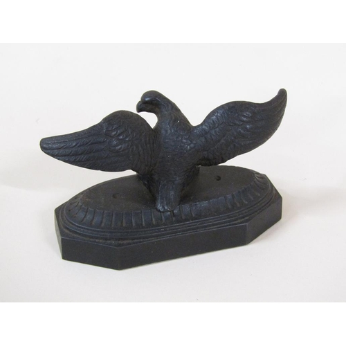 83 - A late Victorian cast iron figure of an eagle with outstretched wings on a shaped rectangular base, ... 