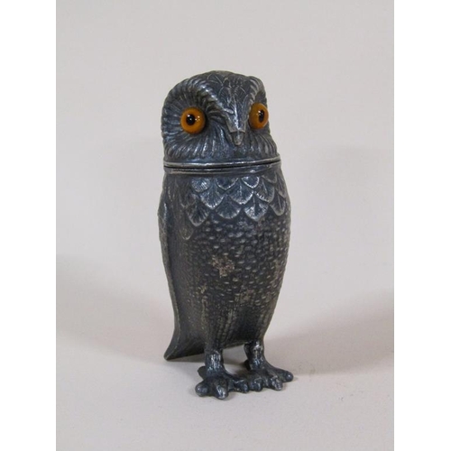 89 - An early 20c pewter pepper pot in the form of a standing owl with glass eyes, 7.5cm h.