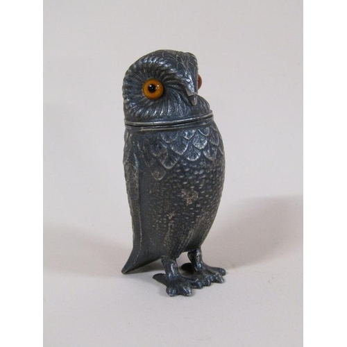 89 - An early 20c pewter pepper pot in the form of a standing owl with glass eyes, 7.5cm h.