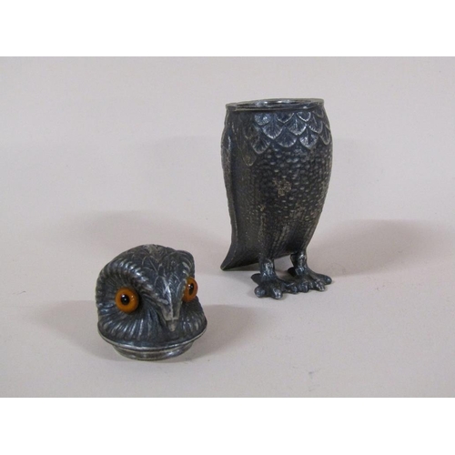 89 - An early 20c pewter pepper pot in the form of a standing owl with glass eyes, 7.5cm h.