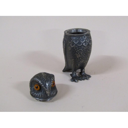 89 - An early 20c pewter pepper pot in the form of a standing owl with glass eyes, 7.5cm h.