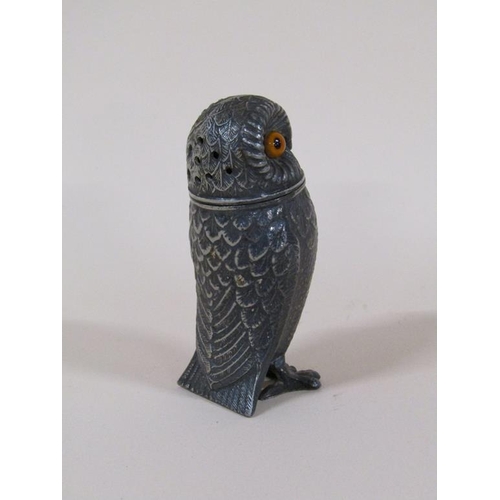 89 - An early 20c pewter pepper pot in the form of a standing owl with glass eyes, 7.5cm h.