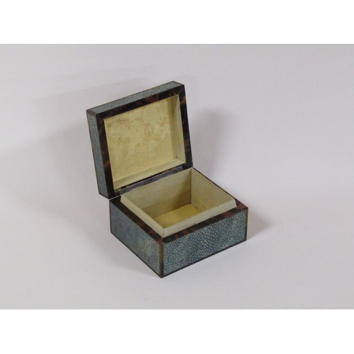 99 - An early 20c shagreen and tortoiseshell cigarette box with an agate stone mount, 12cm w, 6.5cm h.