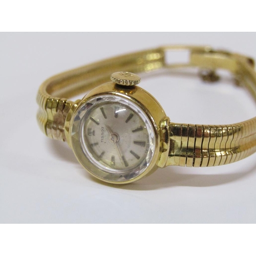 112 - An 18ct gold Tissot ladies watch with faceted glass dial and attached safety chain, 22.6g total weig... 