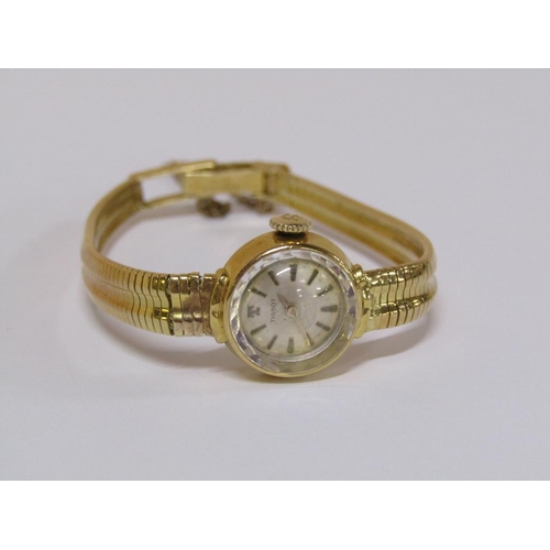 112 - An 18ct gold Tissot ladies watch with faceted glass dial and attached safety chain, 22.6g total weig... 