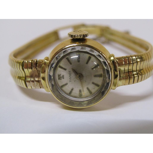 112 - An 18ct gold Tissot ladies watch with faceted glass dial and attached safety chain, 22.6g total weig... 