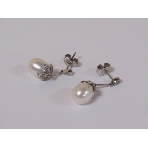 120 - A pair of 18ct white gold diamond and pearl drop earrings.