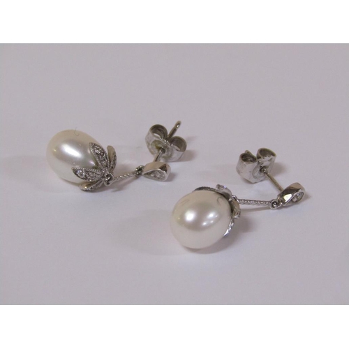 120 - A pair of 18ct white gold diamond and pearl drop earrings.