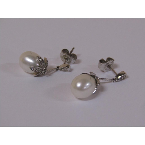 120 - A pair of 18ct white gold diamond and pearl drop earrings.