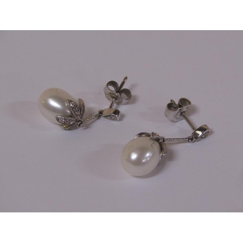 120 - A pair of 18ct white gold diamond and pearl drop earrings.