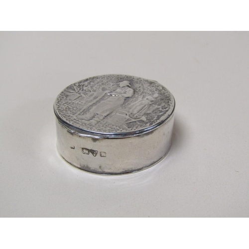 130 - A 19c silver circular box with hinge cover, the cover embossed and chased with the scene of a garden... 