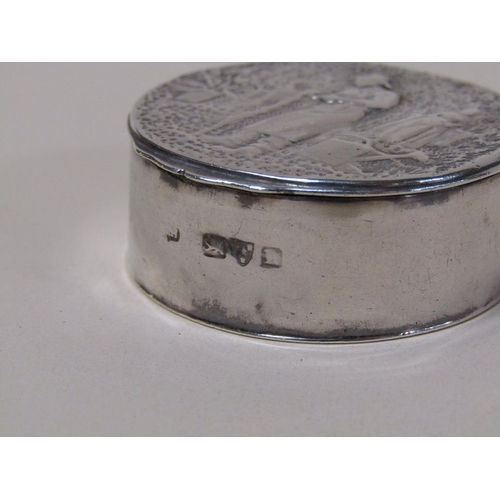 130 - A 19c silver circular box with hinge cover, the cover embossed and chased with the scene of a garden... 