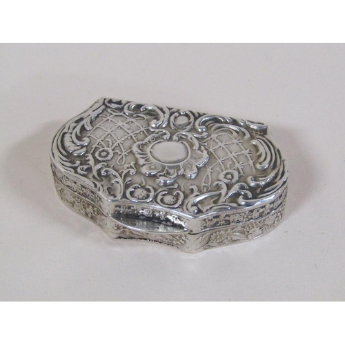 131 - A late 19c/early 20c silver box of quatrefoil form with hinge cover, decorated with lattice work, sc... 