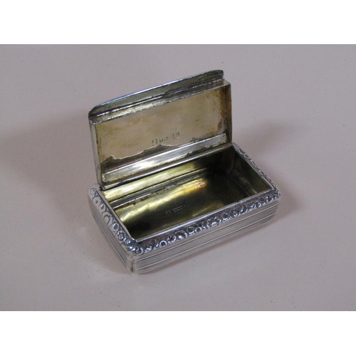 133 - A late Georgian snuff box of rectangular form with a hinge cover, engine turned and with a border of... 