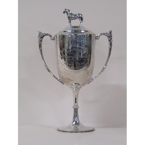 150 - A late Victorian silver two handled trophy cup with lift off cover having standing horse finial, bei... 