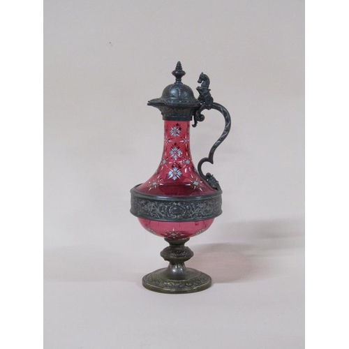 163 - A WMF cranberry claret jug with pewter mounts and base, with enamel decoration, 32cm h.