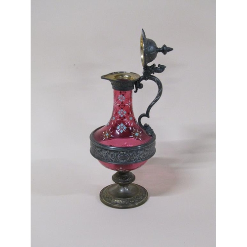 163 - A WMF cranberry claret jug with pewter mounts and base, with enamel decoration, 32cm h.