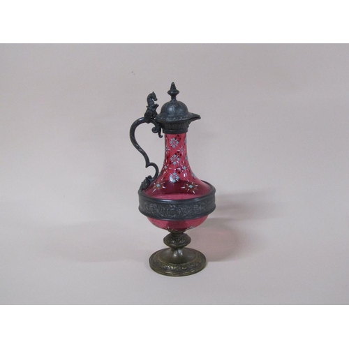 163 - A WMF cranberry claret jug with pewter mounts and base, with enamel decoration, 32cm h.