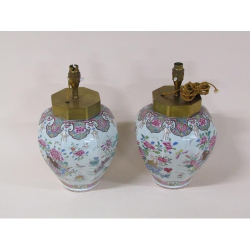 176 - A pair famille rose style porcelain lamps converted from jars, decorated with birds, flowers, insect... 