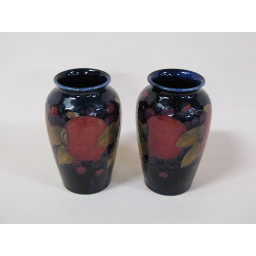 193 - A pair of early 20c Moorcroft Pomegranate vases of baluster form, decorated on a blue ground, painte... 