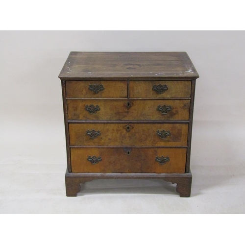 251 - A George III walnut veneered chest of two short and three long graduated drawers on bracket feet, 84... 