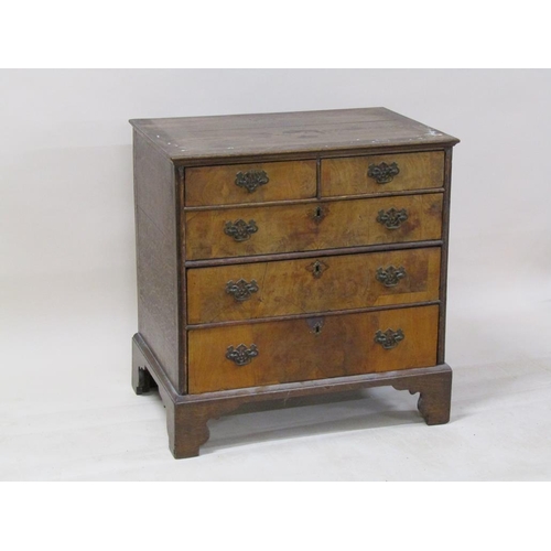 251 - A George III walnut veneered chest of two short and three long graduated drawers on bracket feet, 84... 