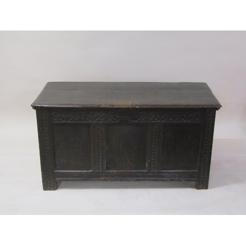 264 - A late 17c/early 18c oak three panel coffer, with a hinge rising cover, carved on stile legs, 132cm ... 