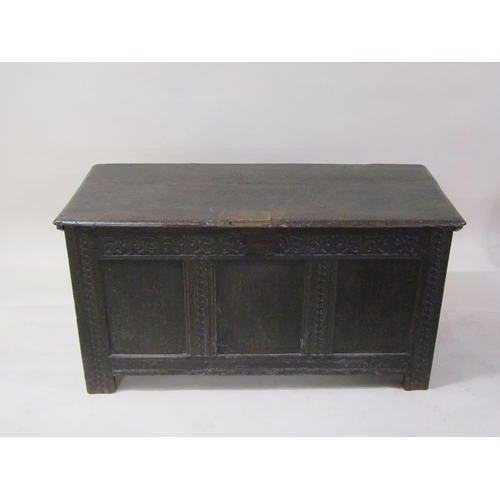 264 - A late 17c/early 18c oak three panel coffer, with a hinge rising cover, carved on stile legs, 132cm ... 