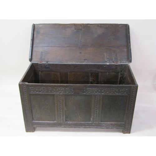 264 - A late 17c/early 18c oak three panel coffer, with a hinge rising cover, carved on stile legs, 132cm ... 