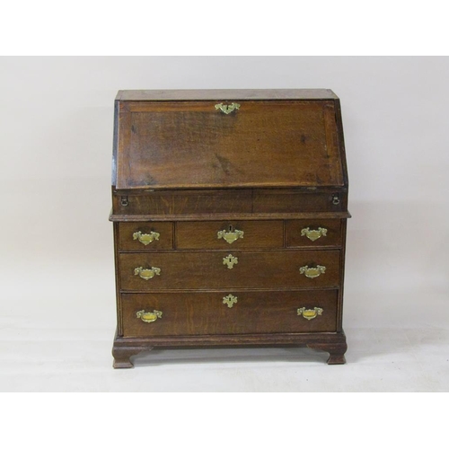 268 - A George III oak bureau with fall front and fitted interior with well, over three short and two long... 