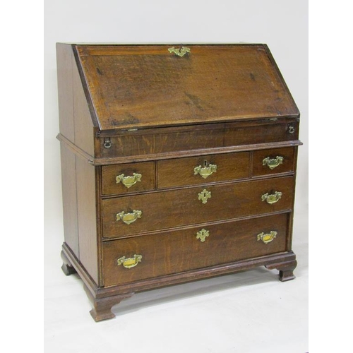 268 - A George III oak bureau with fall front and fitted interior with well, over three short and two long... 