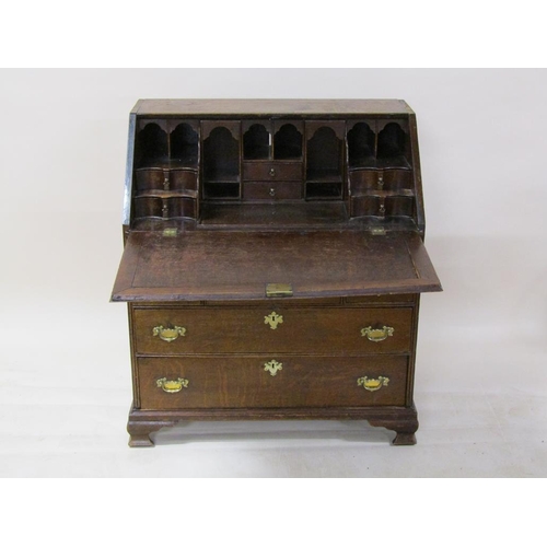 268 - A George III oak bureau with fall front and fitted interior with well, over three short and two long... 