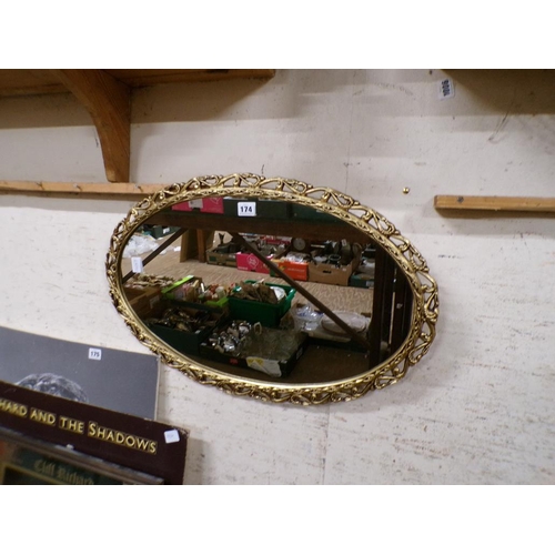 174 - GILT FRAMED OVAL WALL MIRROR