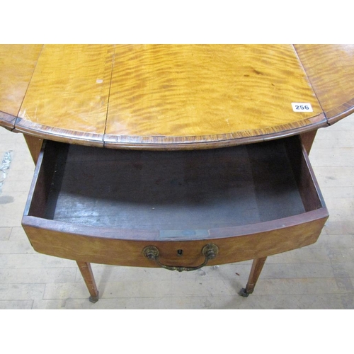 256 - A Regency period satinwood oval Pembroke type table, crossbanded and line inlaid, fitted one end dra... 