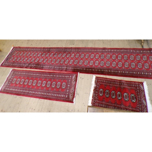 1876 - ORIENTAL RED GROUND PATTERNED RUNNER, 80CM X 622CM; TWO OTHERS - 67CM X 203CM & 65CM X 108CM