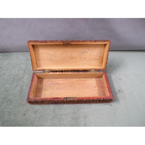 1360 - INDIAN HARDWOOD GLOVE BOX CARVED IN HIGH RELIEF WITH LEAF, FLOWERS AND BUILDINGS 30cms L