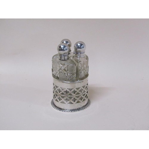 1735A - PIERCED SILVER AND CUT GLASS THREE BOTTLE CLUSTER SCENT BOTTLES BY JOHN GRINSELL & SONS, BIRMINGHAM ... 