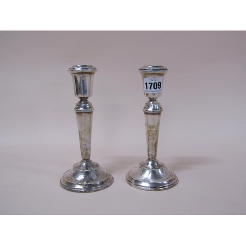 1709 - PAIR OF SILVER CASED FILLED CANDLESTICKS