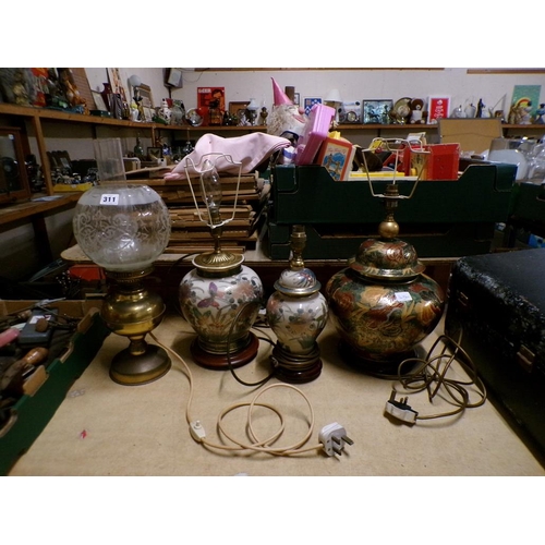 311 - THREE ORIENTAL STYLE CERAMIC LAMPS AND ONE CONVERTED OIL LAMP