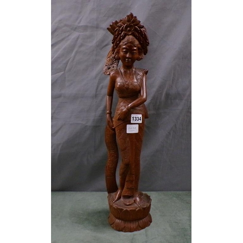 1334 - CARVED WOODEN FIGURE OF A POLYNESIAN LADY - 56cms H