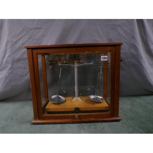 1384 - PAIR OF GLASS CASED CHEMICAL BALANCES 44 cms W