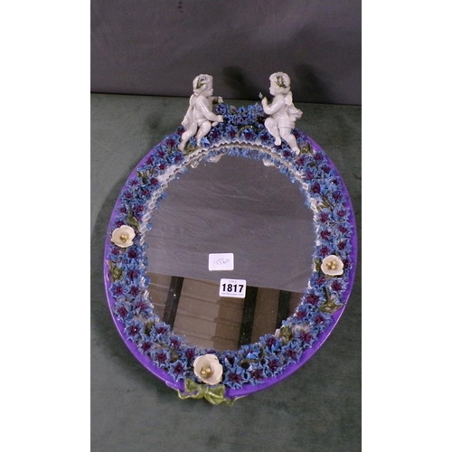 1817 - CONTINENTAL PORCELAIN MIRROR, CHERUB MOUNTED WITH FLOWERS, 32CM W